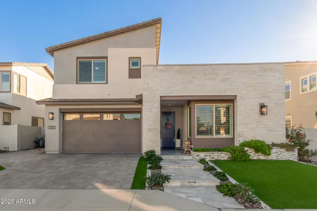 a front view of a house with a yard and garage