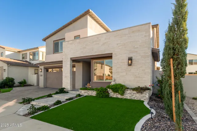 a front view of a house with a yard and garage