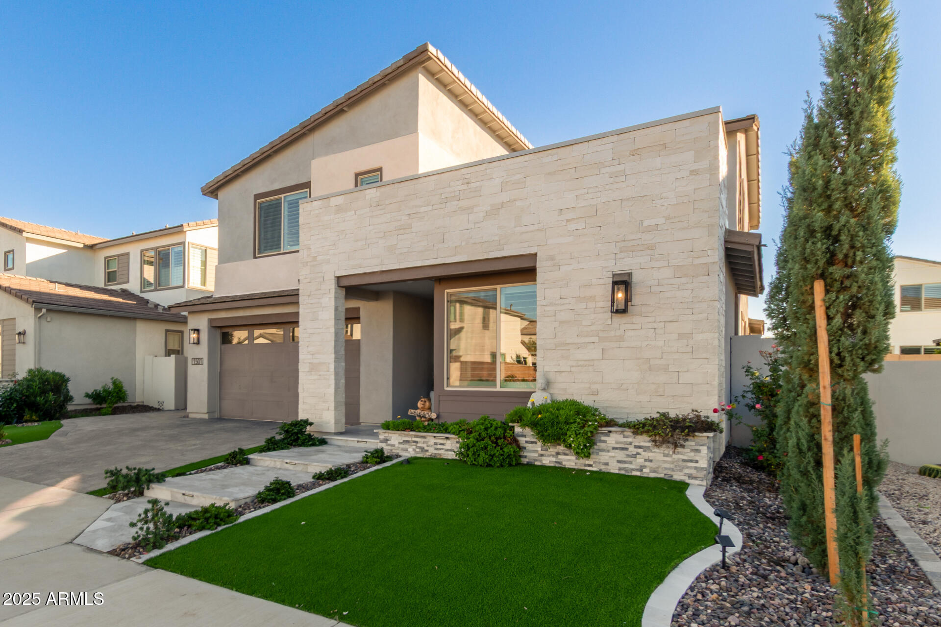 1501 East Rakestraw Lane Gilbert, AZ 85298 - Photo 6 of 71 a front view of a house with a yard and garage