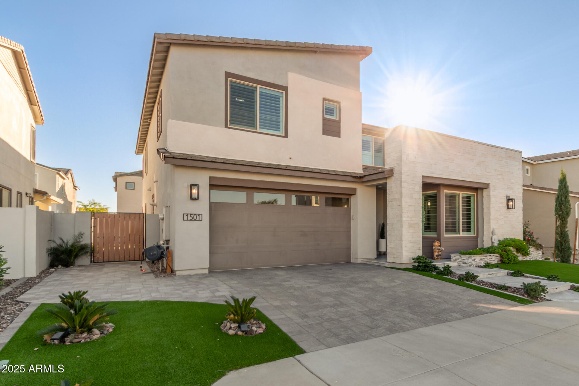 1501 East Rakestraw Lane Gilbert, AZ 85298 - Photo 8 of 71 a front view of a house with a garden and garage