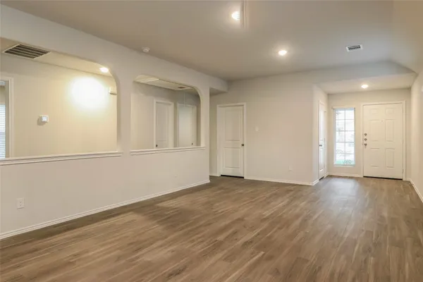 an empty room with wooden floor