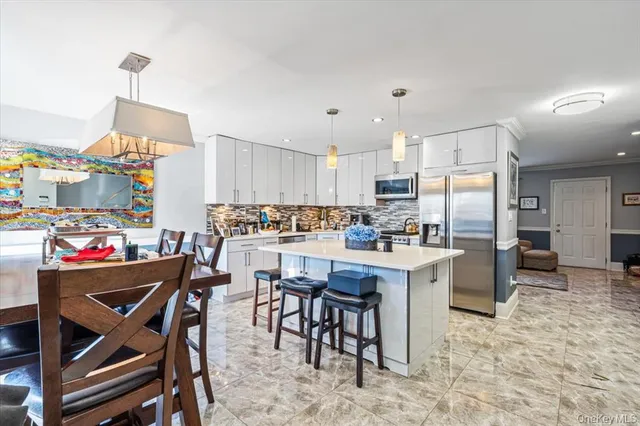 a kitchen with stainless steel appliances granite countertop a refrigerator and a stove top oven