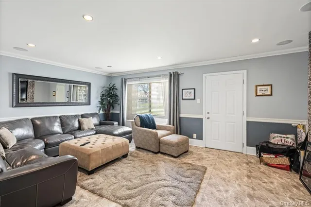 a living room with furniture and painting on the wall