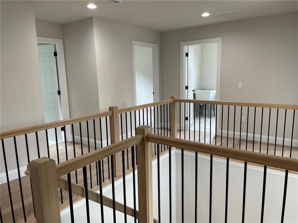 5043 Chapmans Road Orefield, PA 18069 - Photo 23 of 30 Natural wood banisters with sleek black spindles create an open, airy hallway connecting upper-level rooms.