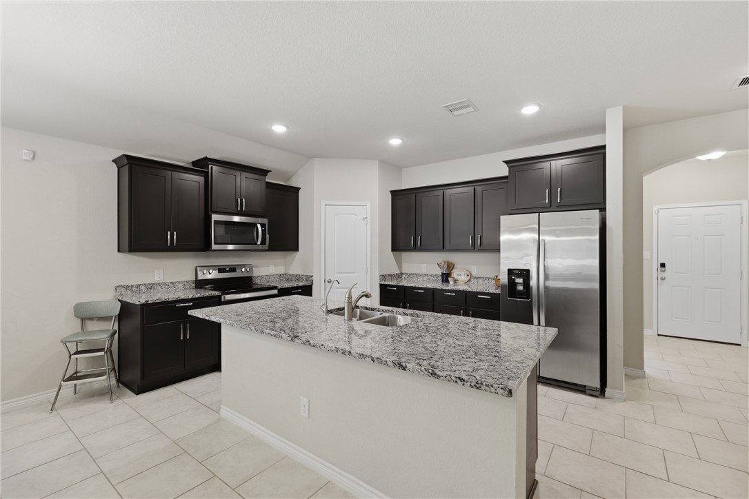 1943 Thorndyke Lane Bryan, TX 77807 - Photo 6 of 28 Large kitchen with counter space for prepping food, entertaining on the island and stainless steel appliances