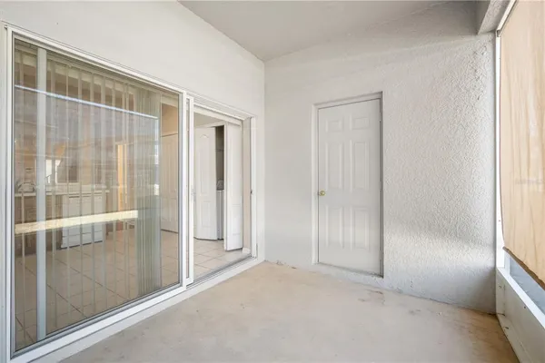 an empty room with sliding glass door