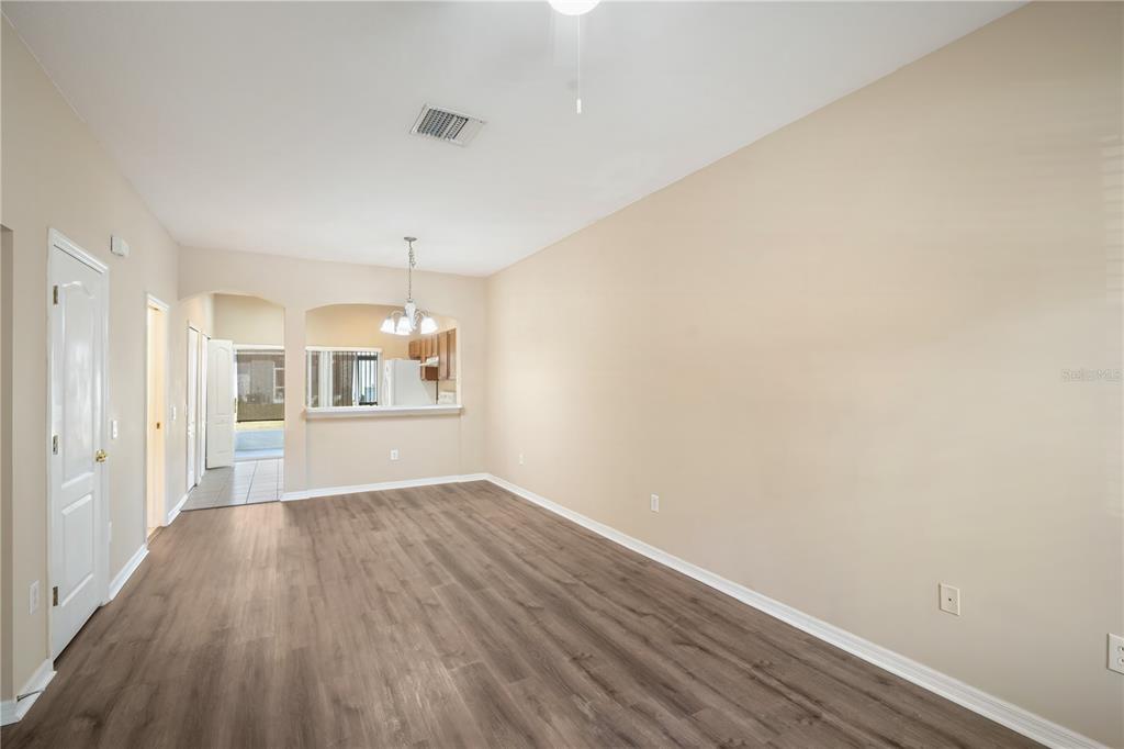 6754 Lake Rochester Lane Gibsonton, FL 33534 - Photo 4 of 26 wooden floor in an empty room with a window