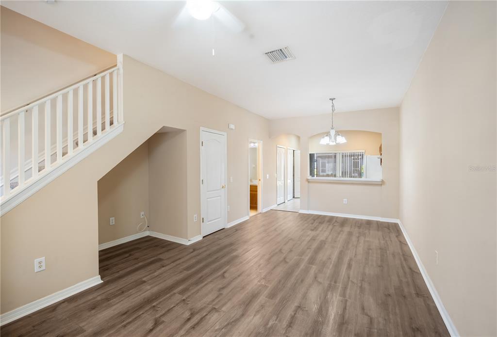 6754 Lake Rochester Lane Gibsonton, FL 33534 - Photo 5 of 26 a view of an empty room with wooden floor and a window