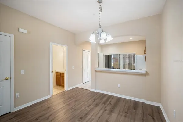 a view of livingroom with chandelier and wooden floor