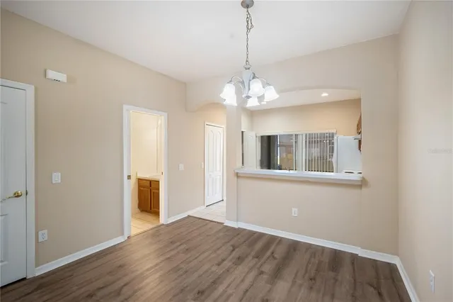 a view of livingroom with chandelier and wooden floor