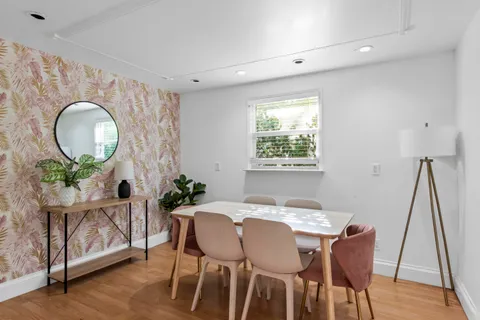 a view of a dining room with furniture and wooden floor