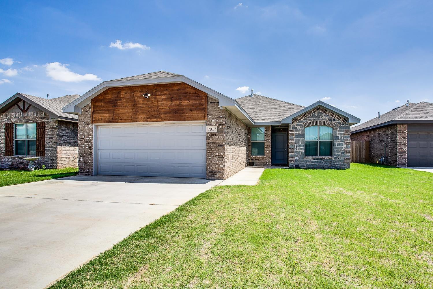 7017 10th Street Lubbock, TX 79416 - Photo 1 of 16 a front view of a house with garden