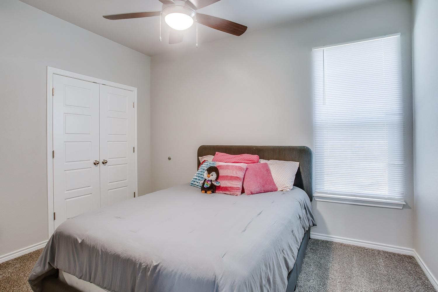 7017 10th Street Lubbock, TX 79416 - Photo 12 of 16 a bedroom with a bed and a window