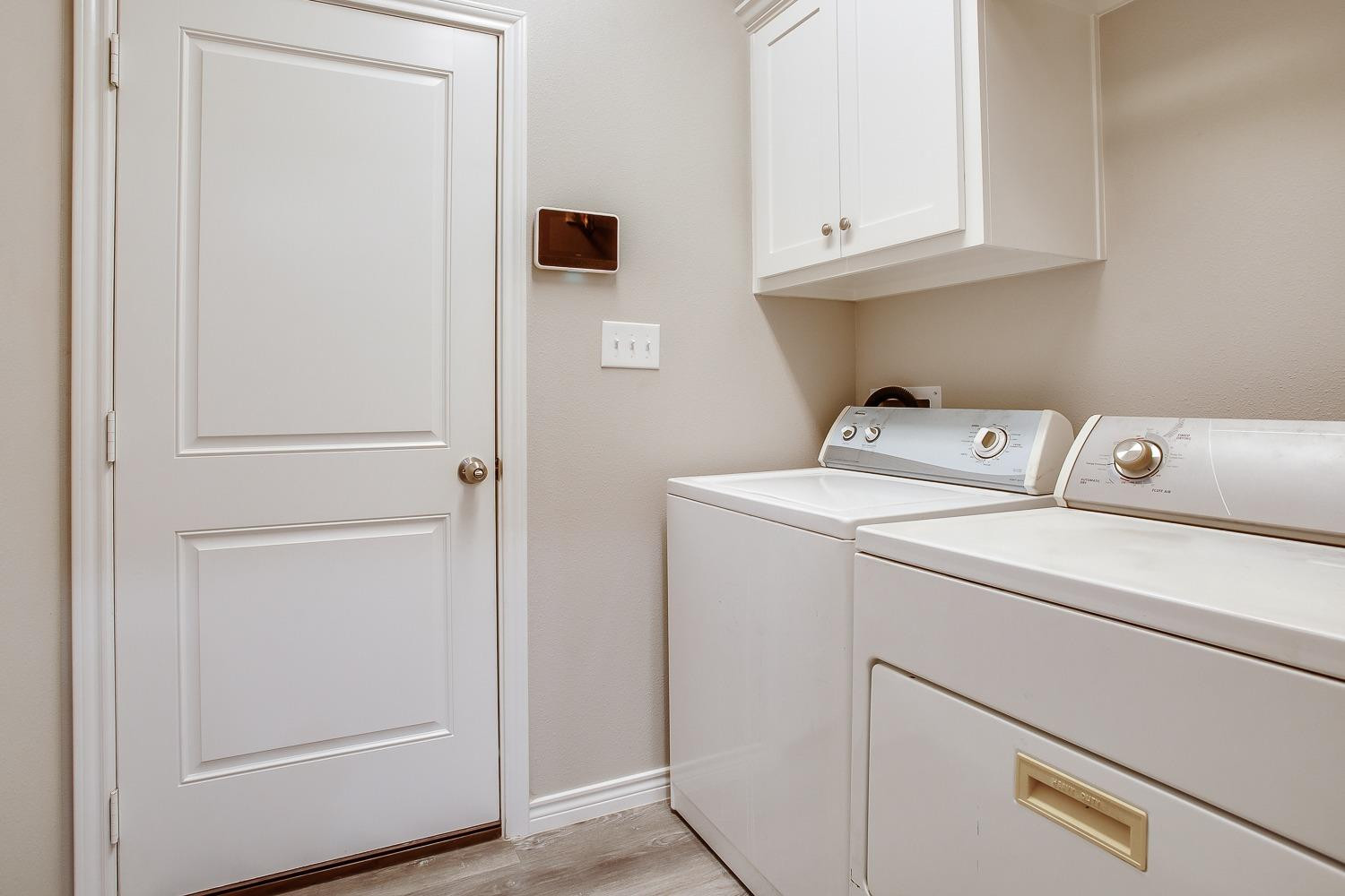7017 10th Street Lubbock, TX 79416 - Photo 14 of 16 a utility room with dryer and washer