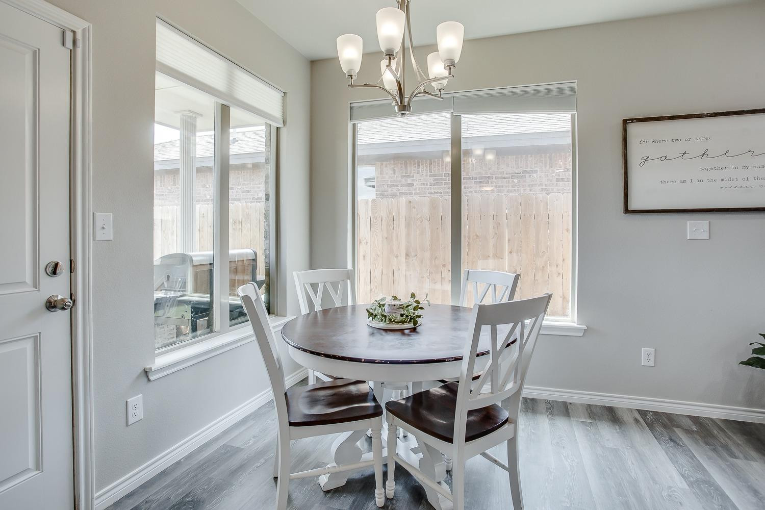 7017 10th Street Lubbock, TX 79416 - Photo 7 of 16 a view of a dining room with furniture wooden floor and a chandelier