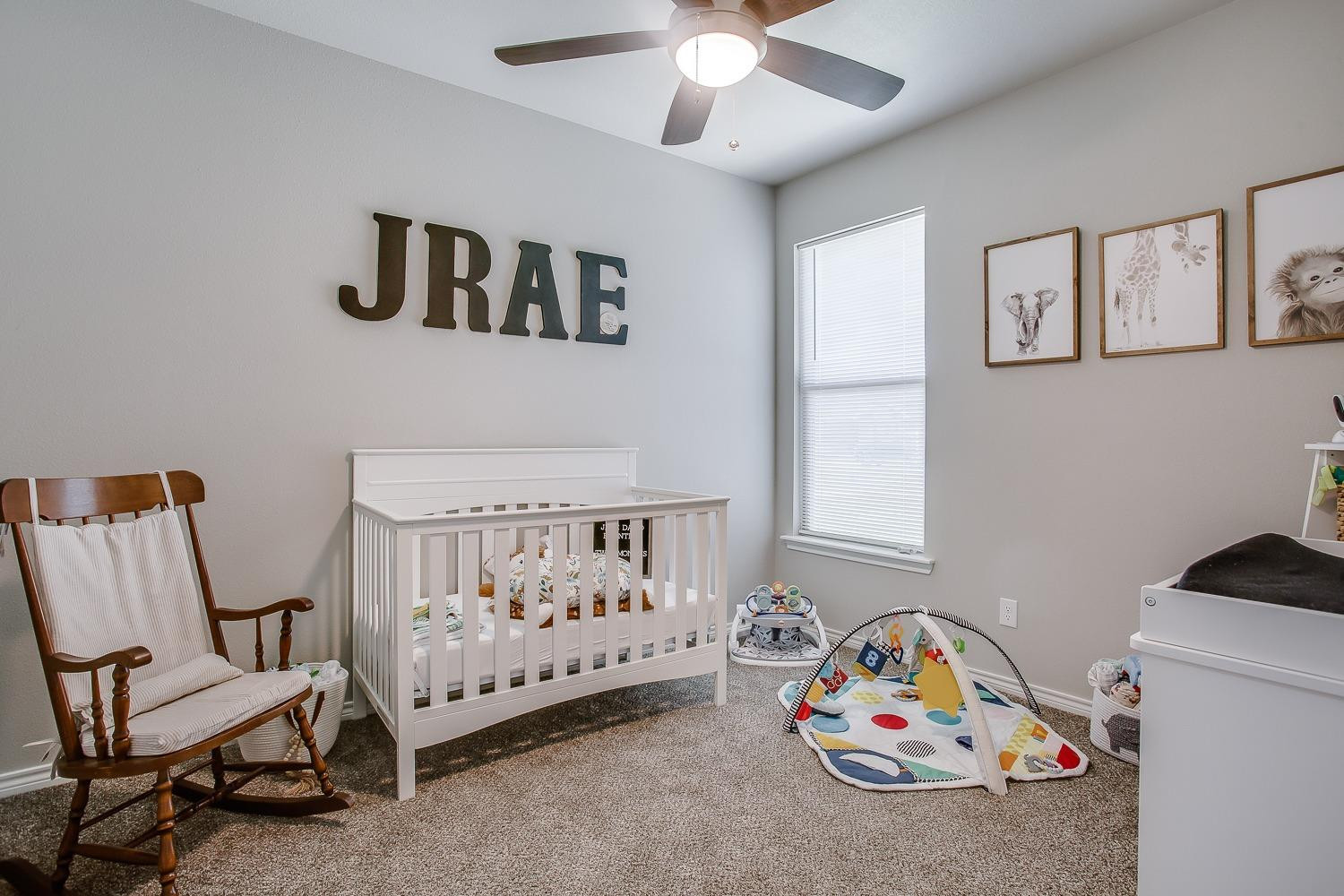 7017 10th Street Lubbock, TX 79416 - Photo 8 of 16 a bedroom with furniture and windows