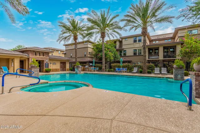 a front view of a house with a garden and tree