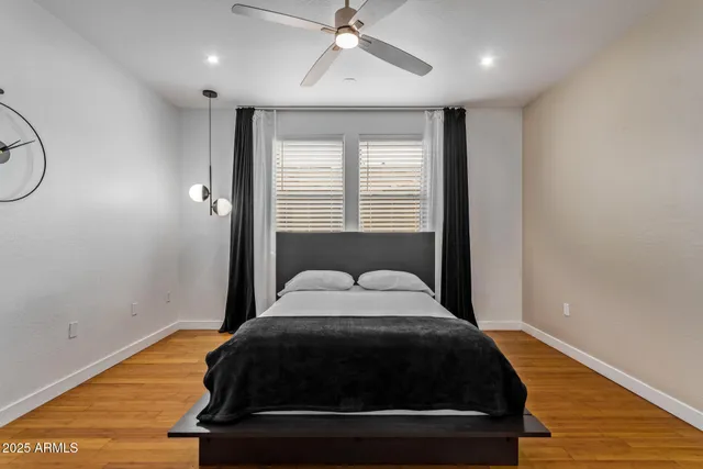 a bedroom with a bed lamp and window