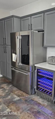 a kitchen with stainless steel appliances granite countertop a refrigerator and a stove