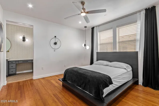a bedroom with a bed and a ceiling fan