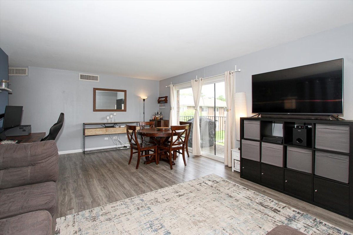 2300 Old Tavern Road, Unit 203 Lisle, IL 60532 - Photo 7 of 26 a living room with furniture and a flat screen tv