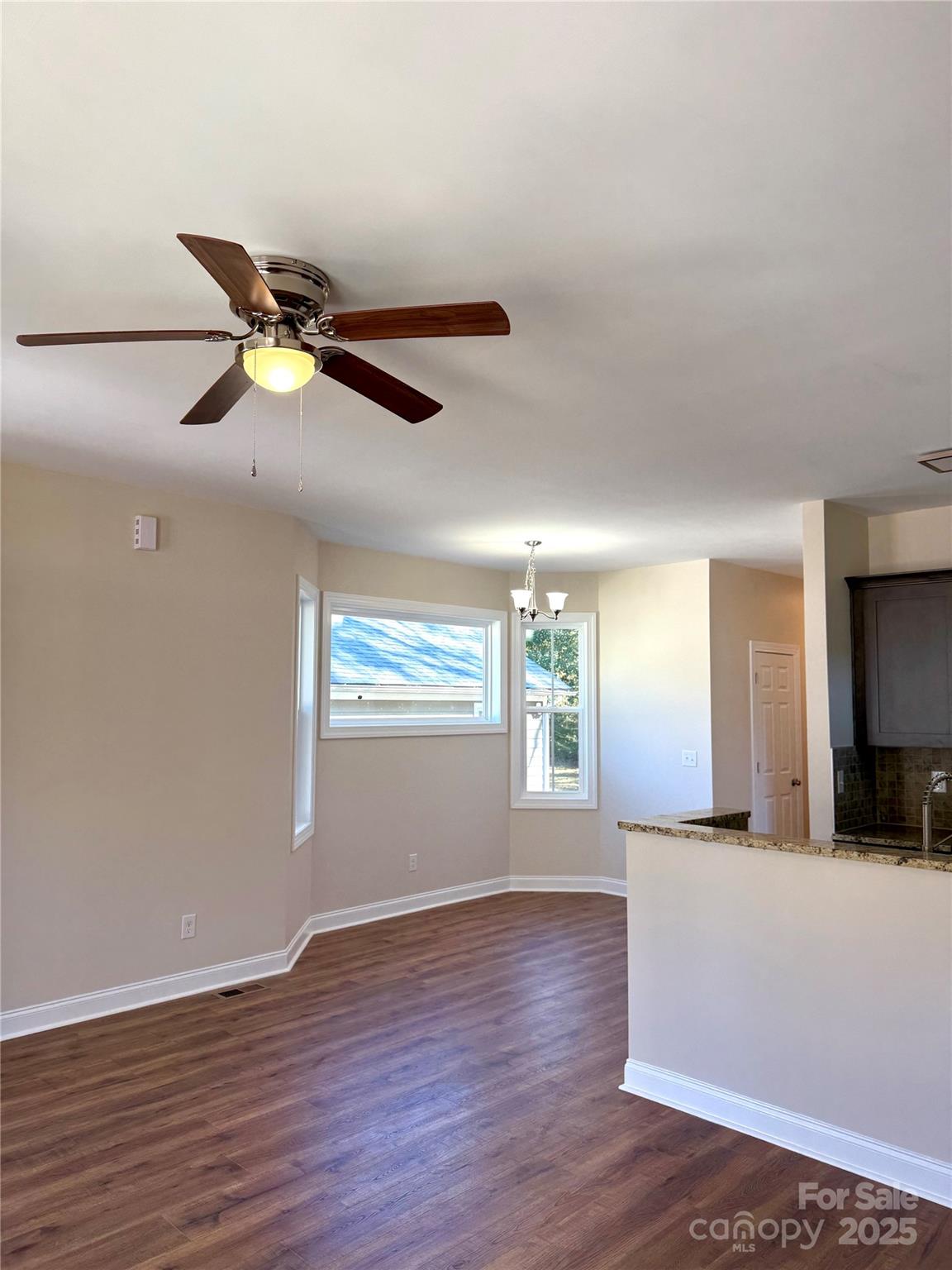 341 Broad Drive Southwest Concord, NC 28025 - Photo 3 of 7 a view of a livingroom with a ceiling fan and wooden floor
