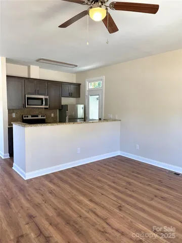 a view of a kitchen with a sink microwave and cabinets