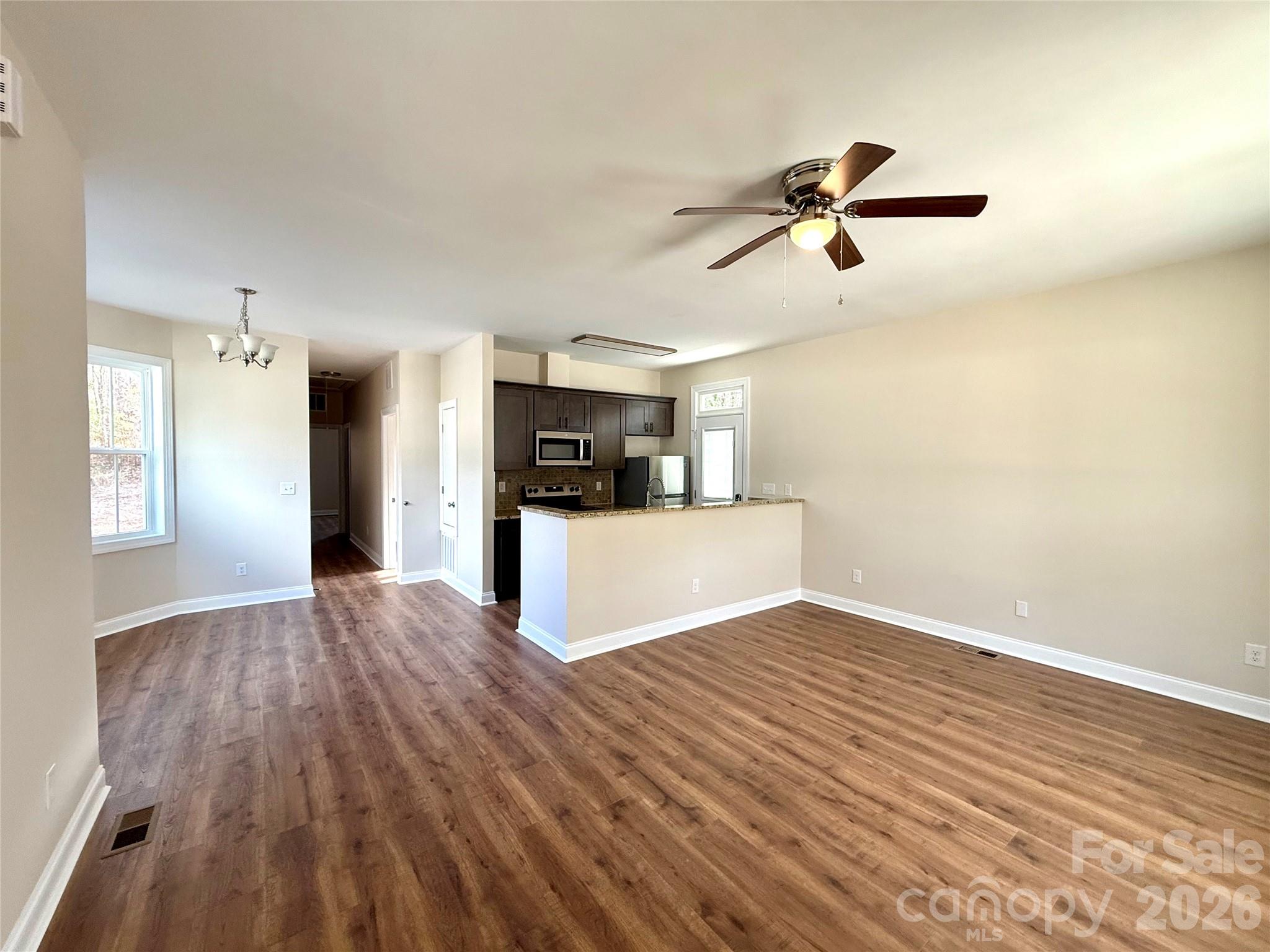 341 Broad Drive Southwest Concord, NC 28025 - Photo 4 of 16 a view of a kitchen with a sink and wooden floor