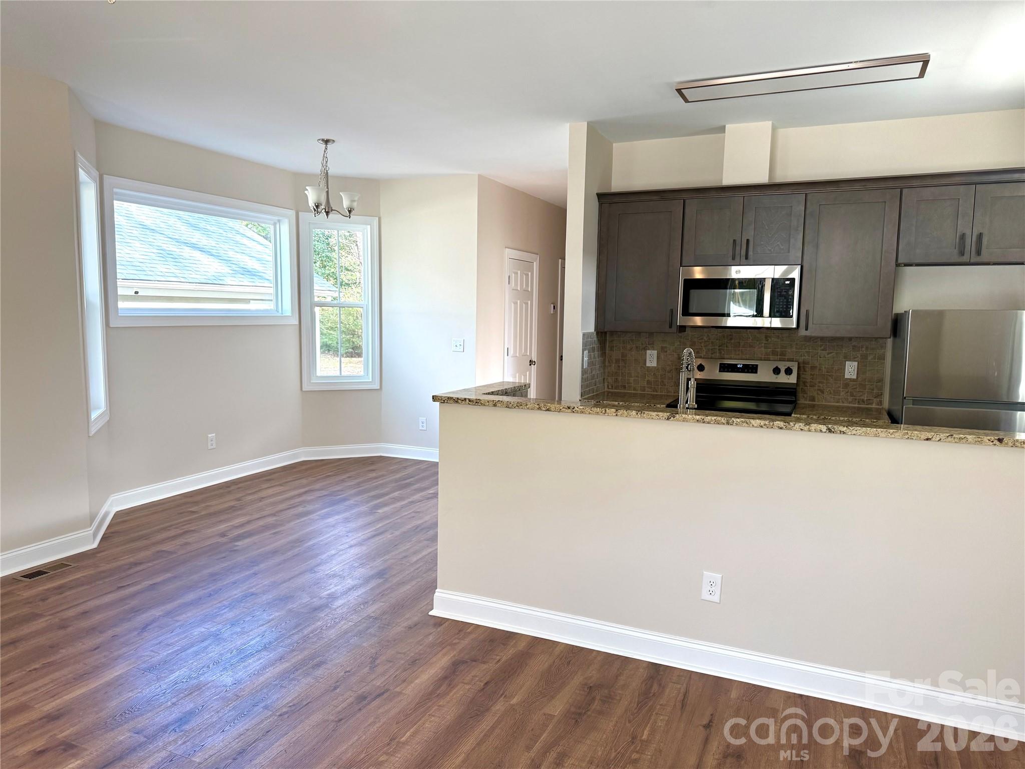 341 Broad Drive Southwest Concord, NC 28025 - Photo 5 of 16 a view of kitchen with granite countertop cabinets and wooden floor