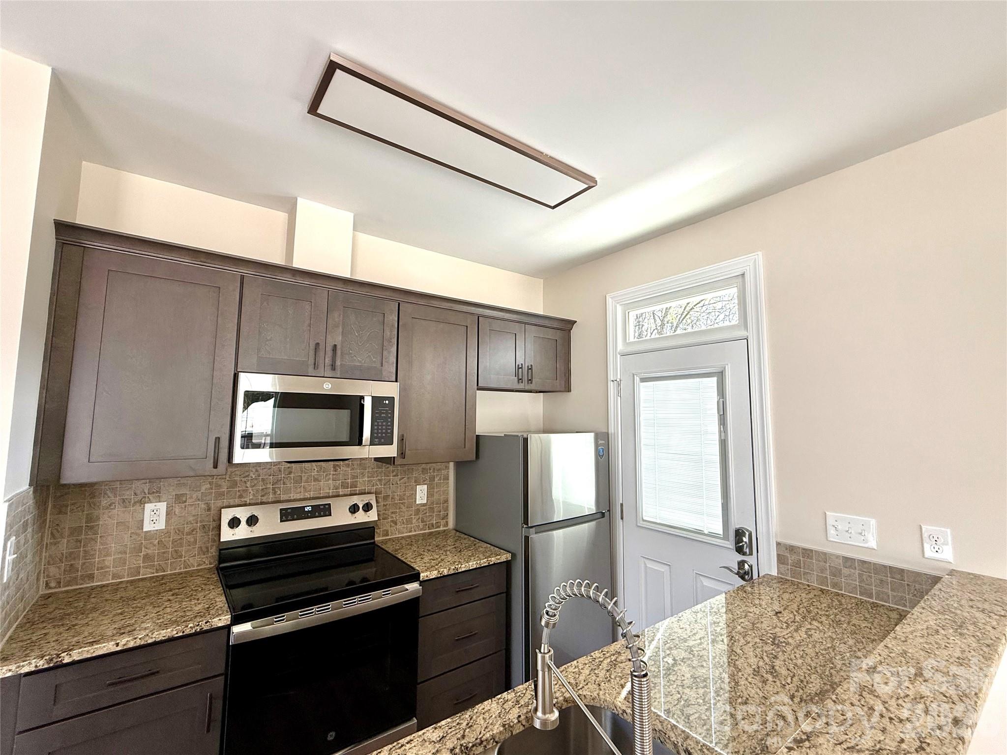341 Broad Drive Southwest Concord, NC 28025 - Photo 6 of 16 a kitchen with a refrigerator stove and microwave