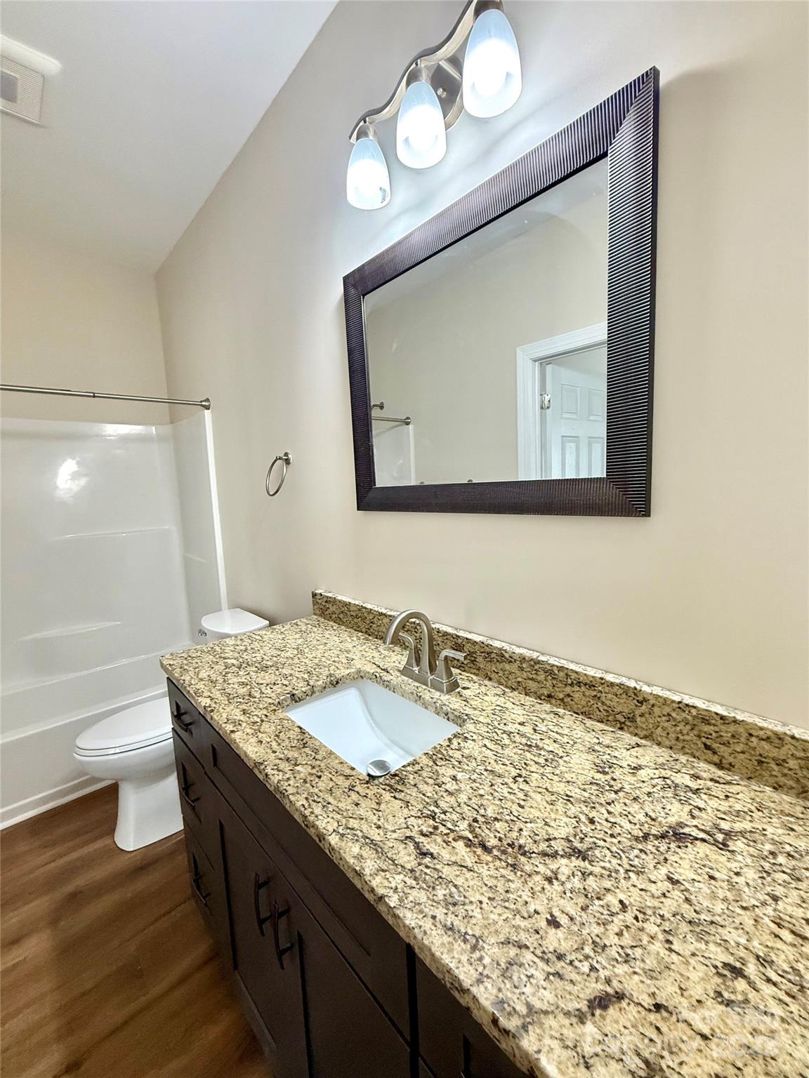 341 Broad Drive Southwest Concord, NC 28025 - Photo 7 of 7 a bathroom with a granite countertop sink and a mirror