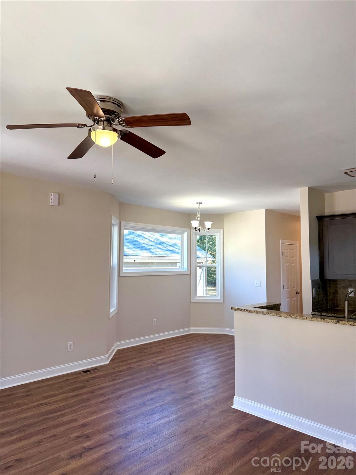 341 Broad Drive Southwest Concord, NC 28025 - Photo 9 of 16 a view of a livingroom with a ceiling fan and wooden floor