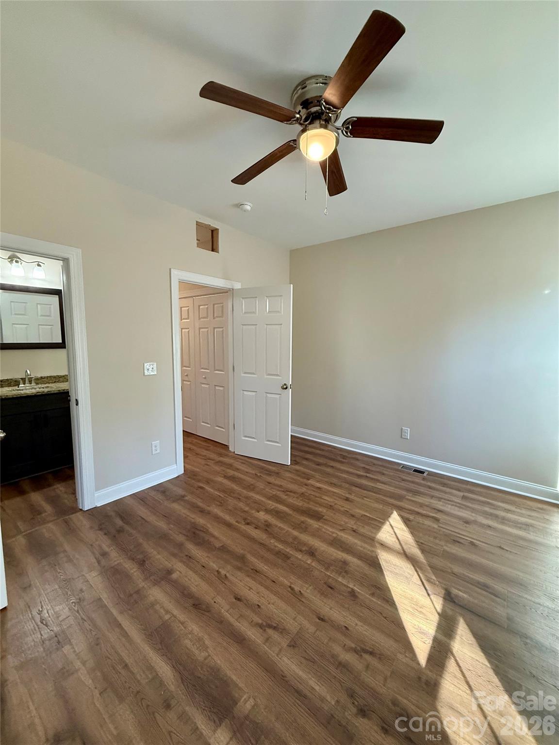341 Broad Drive Southwest Concord, NC 28025 - Photo 10 of 16 an empty room with wooden floor fan and windows