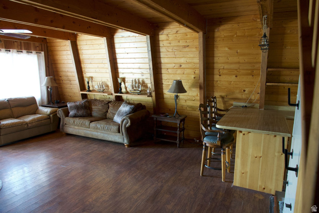 140 East Rim Road Duck Creek Village, UT 84762 - Photo 41 of 45 Living area with dark wood-style flooring and wood walls