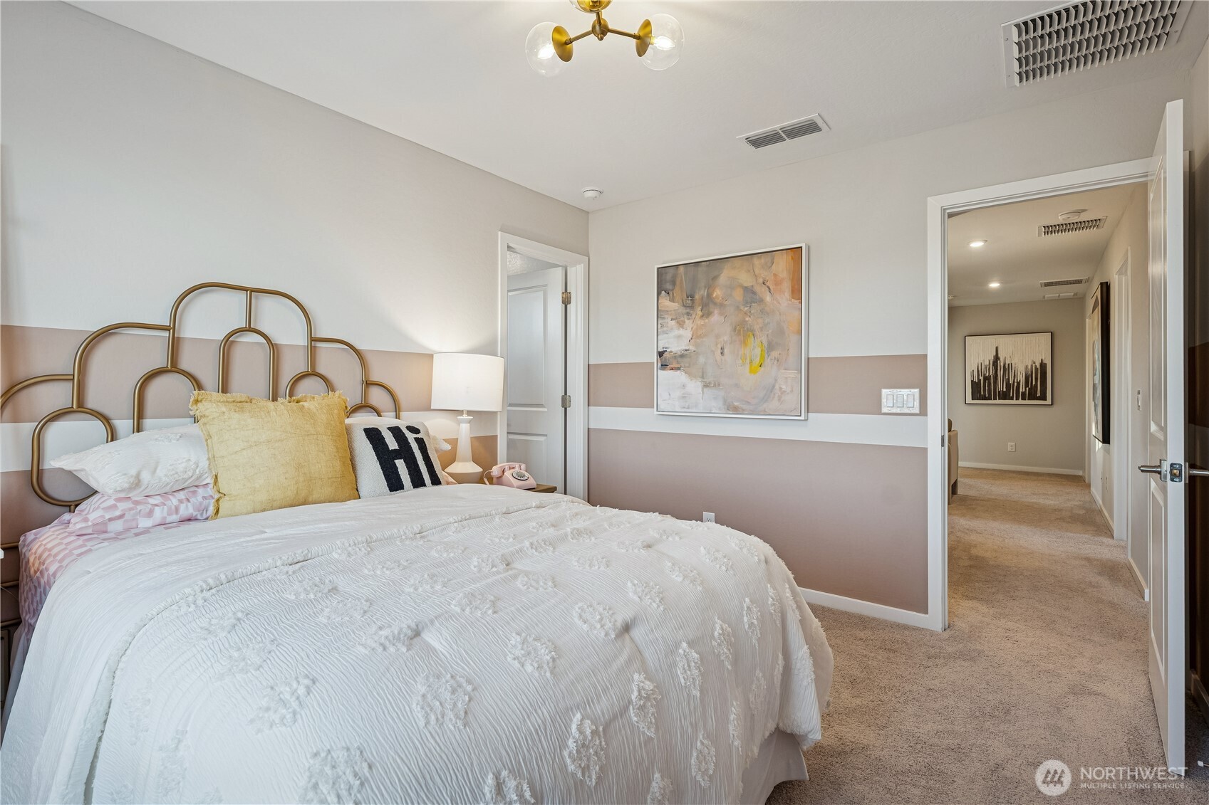 9816 Ferns Loop Southeast Yelm, WA 98597 - Photo 11 of 20 a bedroom with a large bed and a chandelier