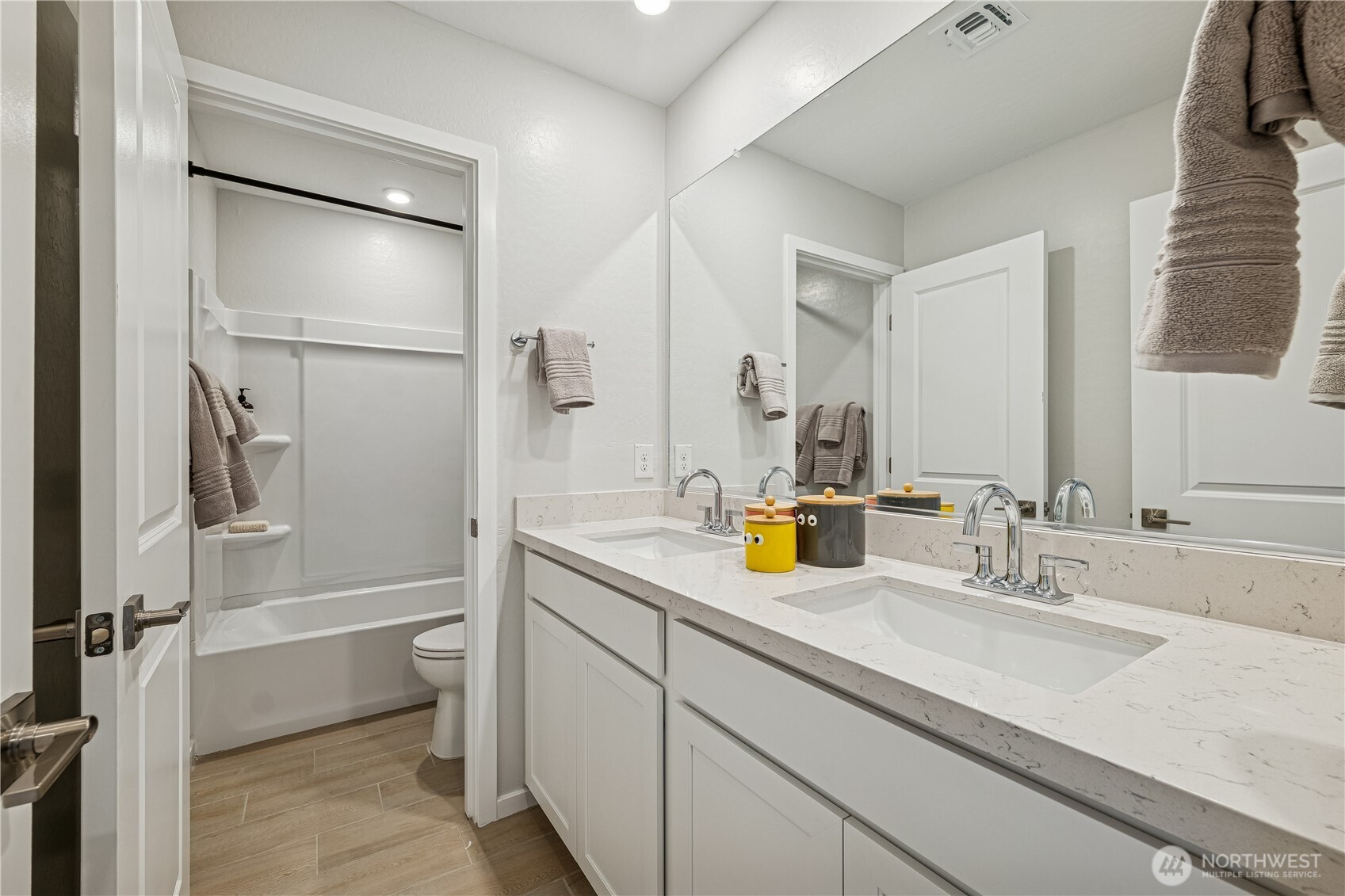 9816 Ferns Loop Southeast Yelm, WA 98597 - Photo 13 of 20 a bathroom with a tub sink and mirror