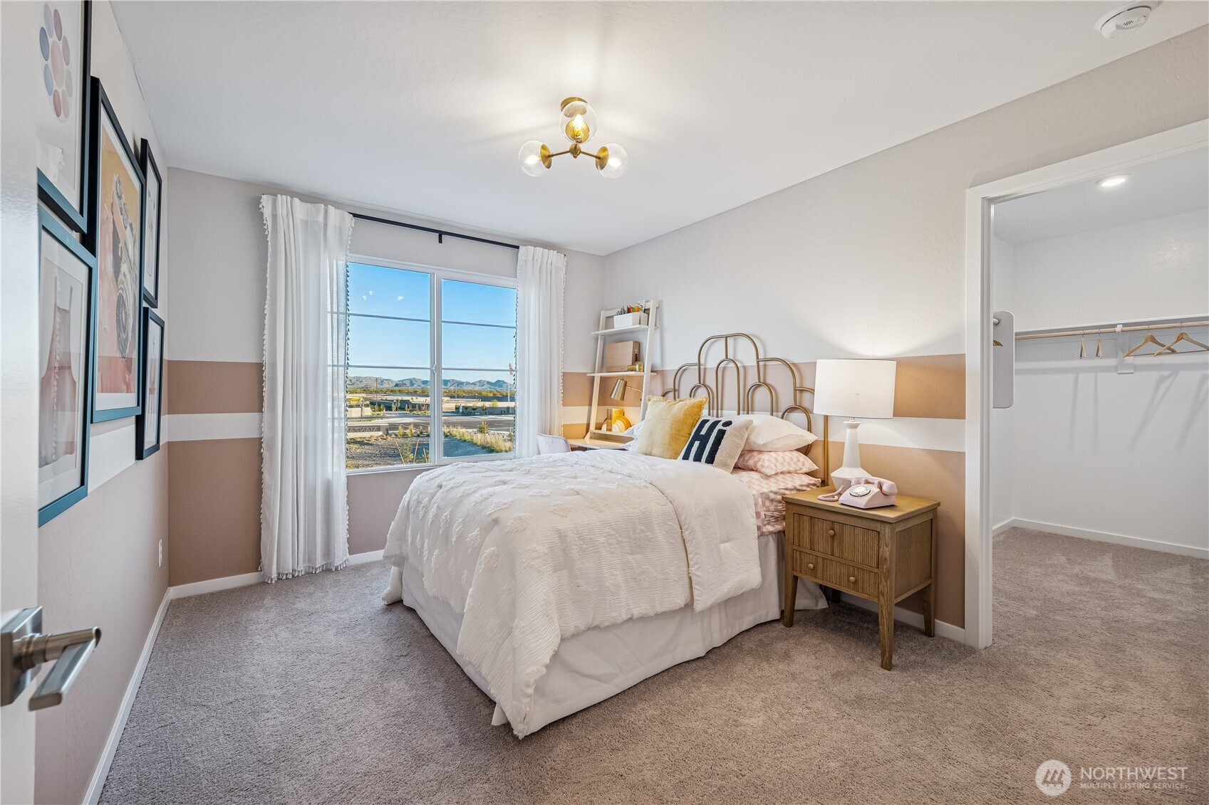 9816 Ferns Loop Southeast Yelm, WA 98597 - Photo 10 of 20 a bedroom with a bed and a chandelier