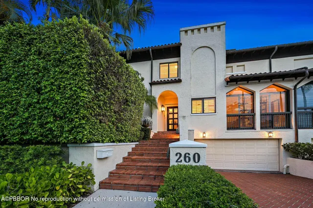 a front view of a house with a garden