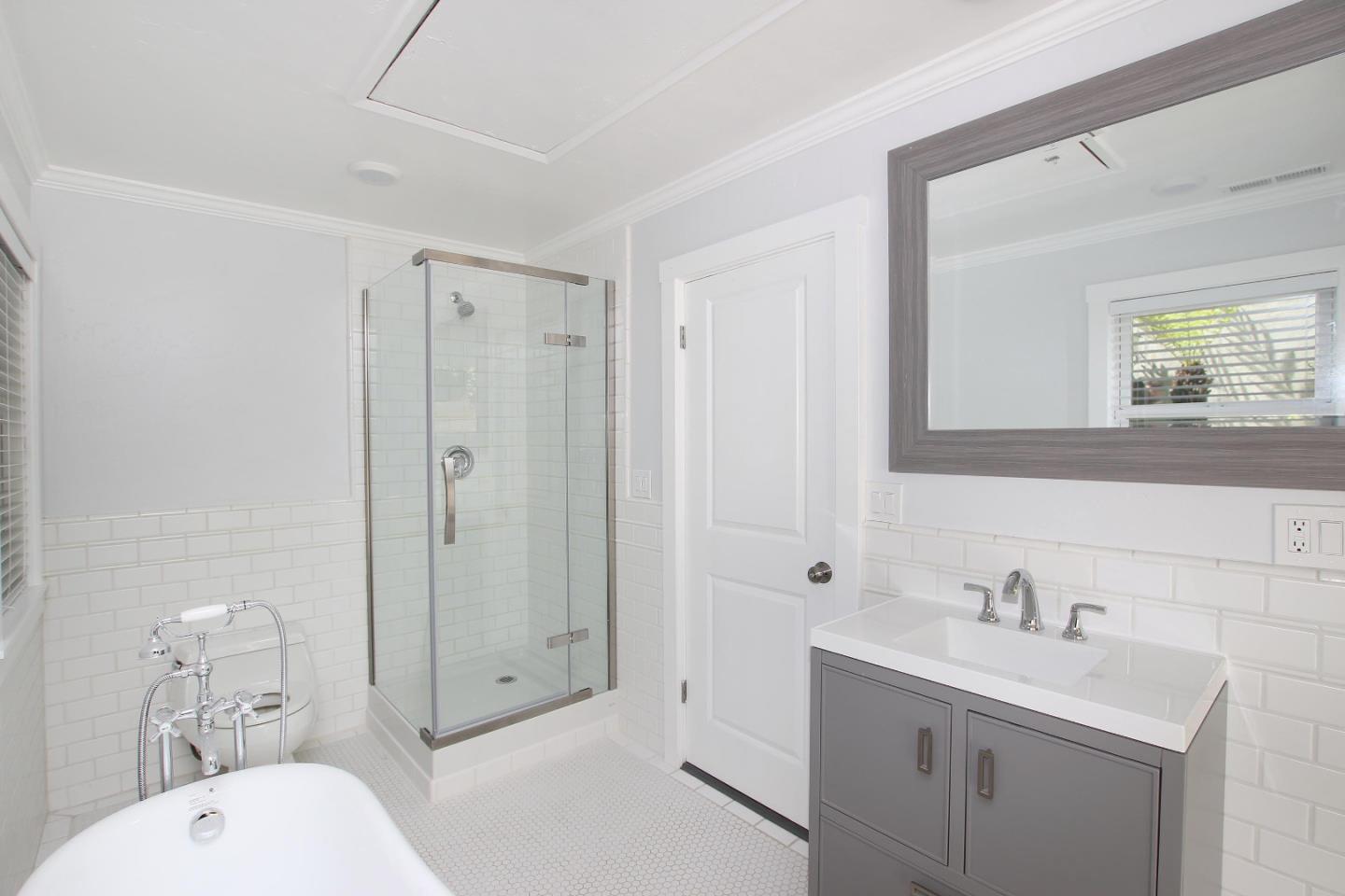 208 Cherry Avenue Capitola, CA 95010 - Photo 16 of 30 a bathroom with a toilet a sink a mirror a window and vanity