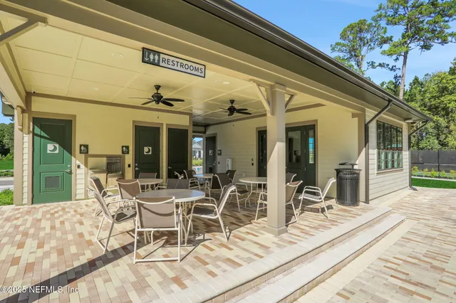 a dining room with wooden floor and furniture