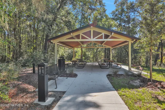 a view of a patio with table and chairs under an umbrella