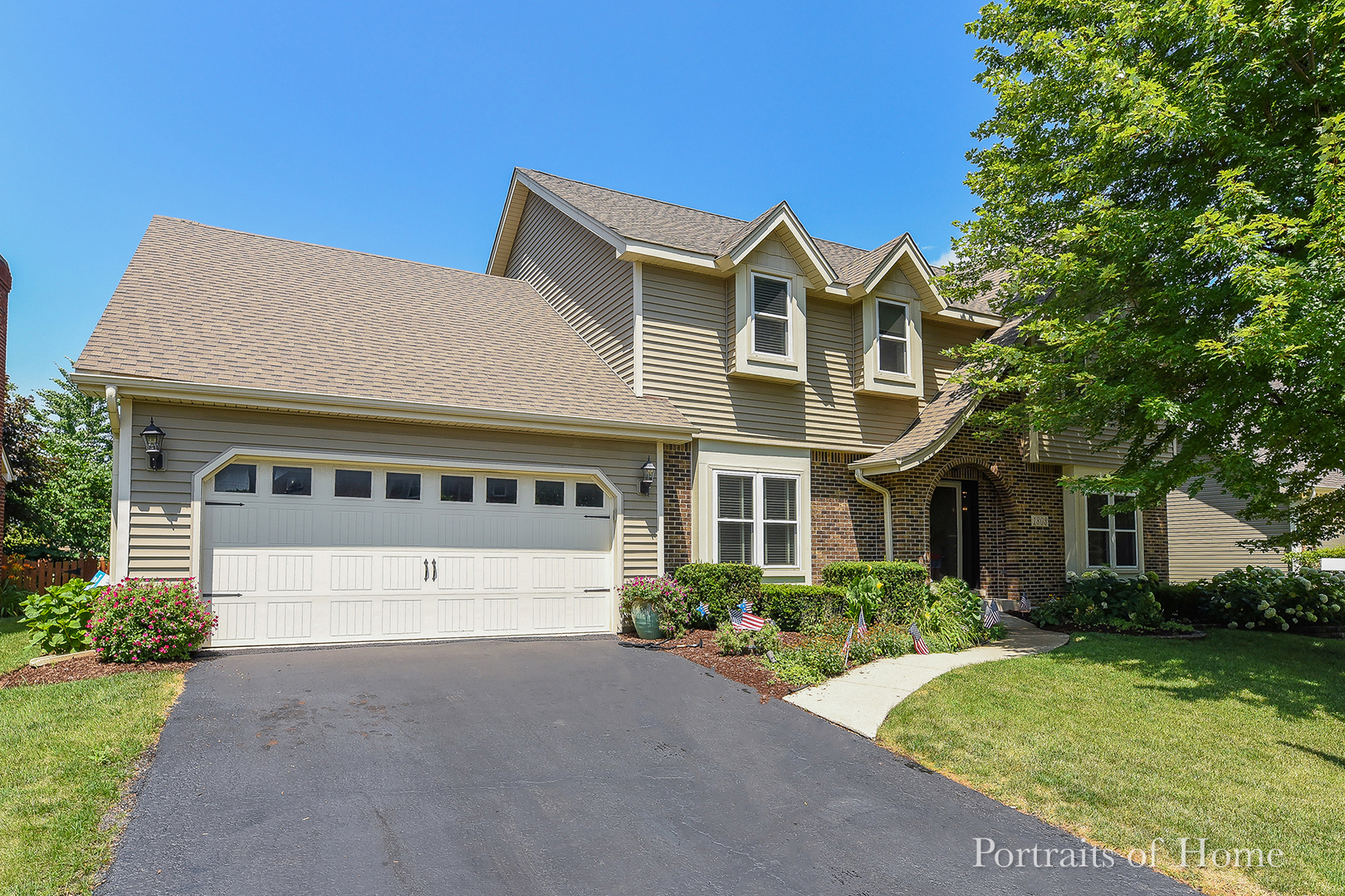 1803 Denison Road Naperville, IL 60565 - Photo 1 of 24 a front view of a house with a yard and garage