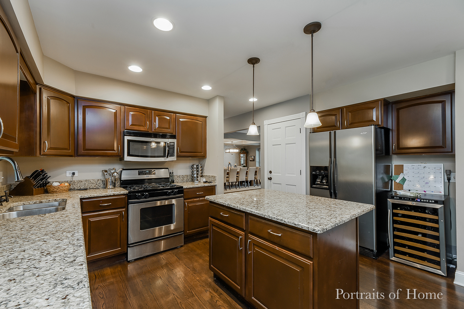 1803 Denison Road Naperville, IL 60565 - Photo 5 of 24 a kitchen with stainless steel appliances granite countertop a sink a stove top oven and refrigerator