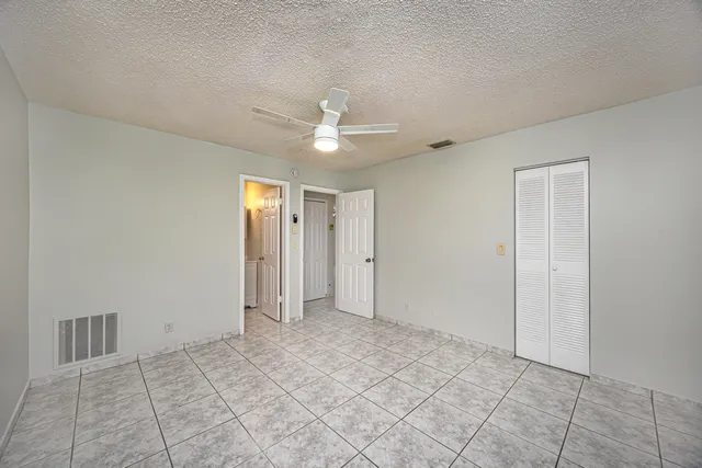 a view of an empty room with a ceiling fan
