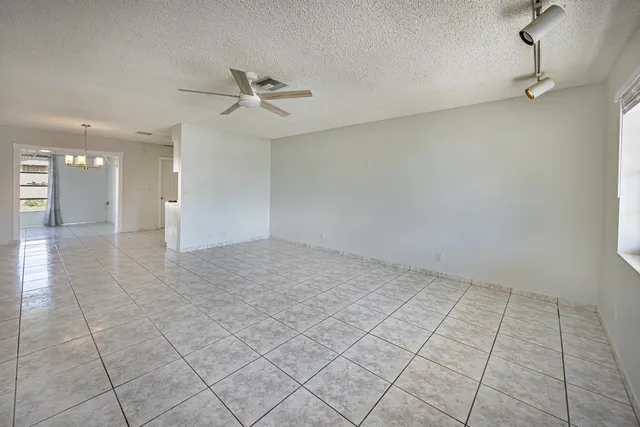 an empty room & view of a bathroom
