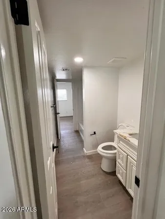 a bathroom with a toilet a sink and a mirror