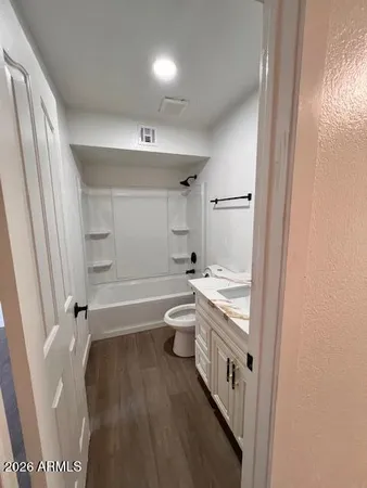 a bathroom with a granite countertop sink a toilet a tub and shower