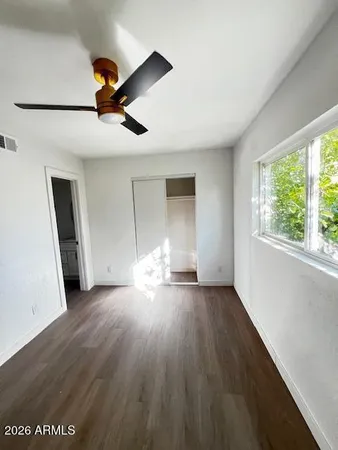 wooden floor in an empty room with a window