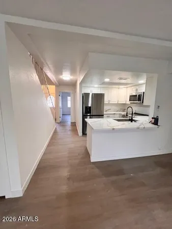 a view of kitchen with microwave and cabinets