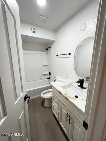 a bathroom with a sink a toilet and a mirror